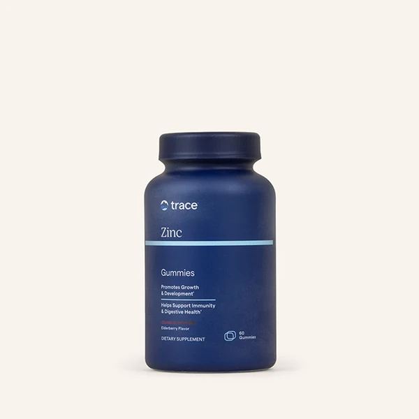 Blue supplement bottle labeled 'trace Zinc' on a white background