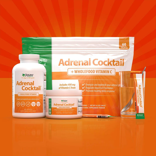 Jigsaw Adrenal Cocktail supplement with Wholefood Vitamin C powder, capsules, and stick packs on orange background